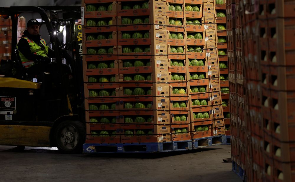 cHJpdmF0ZS9sci9pbWFnZXMvd2Vic2l0ZS8yMDIzLTAzL2ZsNDk3OTcyMzQ2NjgtaW1hZ2UuanBn A forklift operator shuttles a pallet loaded with boxes of watermelons as fruit shipments arrive at the Port of Philadelphia in Philadelphia, Pa., April 16, 2020. More: CBP photo by Glenn Fawcett. Original public domain image from Flickr